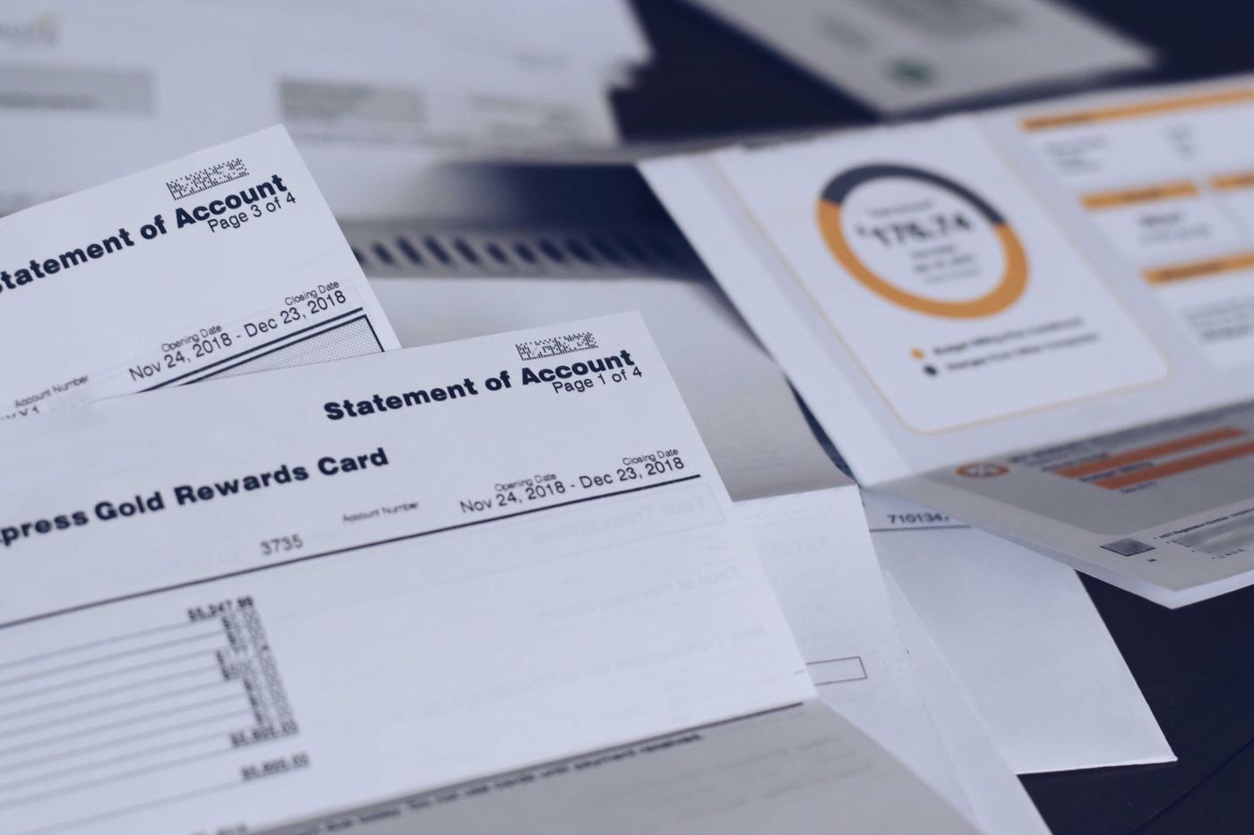 Scattered utility bills and credit card statements